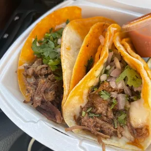 two tacos in a styrofoam container