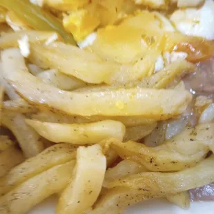 Raw greasy french fries Huevos Rancheros and beans that had a hint of a pine-sol taste. no rice which was added later and tasteless