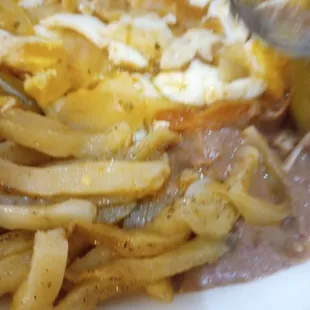 Raw greasy french fries Huevos Rancheros and beans that had a hint of a pine-sol taste. no rice which was added later and tasteless