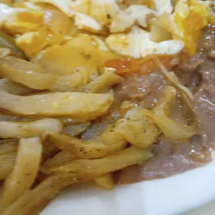 Raw greasy french fries Huevos Rancheros and beans that had a hint of a pine-sol taste. no rice which was added later and tasteless