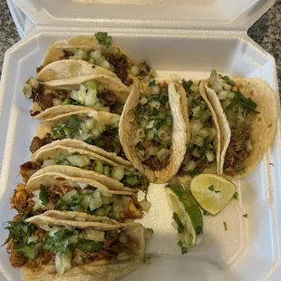 three tacos in a styrofoam container
