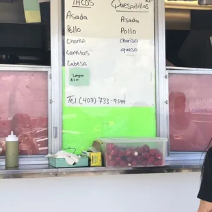 a woman standing in front of a food truck