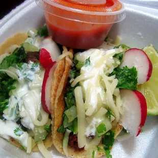 Beef tongue and pork tacos with red salsa.