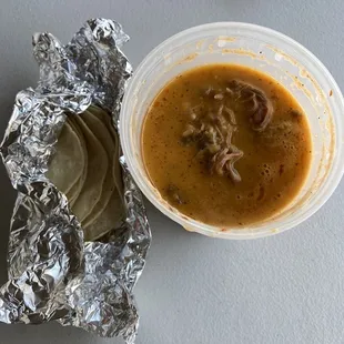 Birria soup with a side of hot tortillas