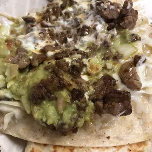 Inside of that Super Quesadilla! Guac, sour cream, some grilled onions, cheese and carne asada!!!