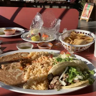 Pollo and Asada taco, rice and beans