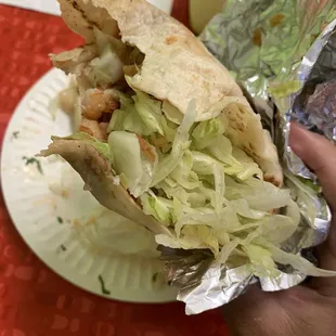 Horrible shrimp taco wrapped half assed with old lettuce, beans and hard rice.