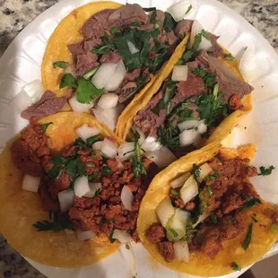 Top tacos are lengua bottom 2 are pastor all on corn tortillas.