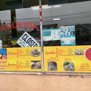 a storefront window with signs
