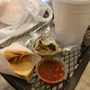 Almost gone lengua burrito, chips, salsa and large horchata.