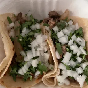 2 carne asada tacos with onion and cilantro