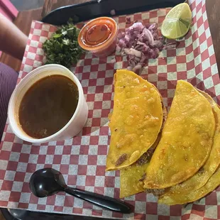 a tray of tacos and salsa