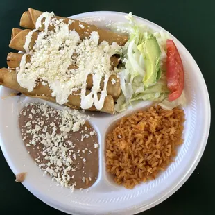 Flautas with rice, beans and salad.