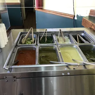 Closer look at the self-serve sauce and toppings bar.