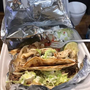 a hand holding a plate of food