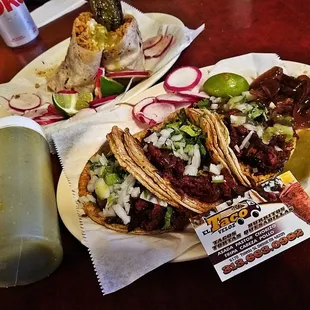 two plates of tacos and a drink