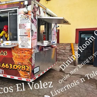 a taco truck parked in front of a building