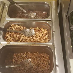 Barbacoa on top, chicken in middle, bisteak on bottom, onions/cilantro on right.