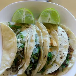 Homemade Corn tortilla, seasoned bisteak, onions, cilantro, lime and homemade red salsa.