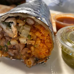 a burrito with a side of salsa