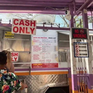 a woman standing in front of a food truck