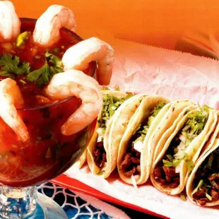 a plate of tacos and a cocktail