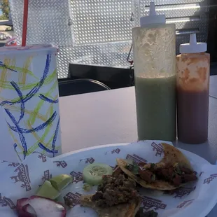 Aqua fresca(4.5), carna asada/pastor tacos@3.25 under canopy at table in front.