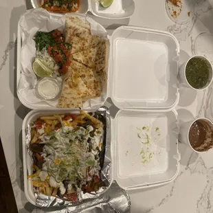 Birria taco, adobada quesadilla carne asada fries and California burrito