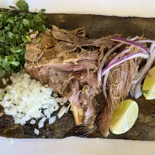 Barbacoa de borrego served on Maguey, broth on the side for me.