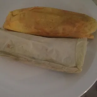 a white plate with two burritos on it