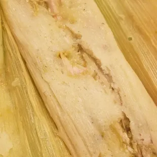two tamales wrapped in plastic wrap