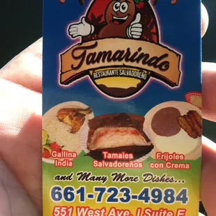 a hand holding a business card