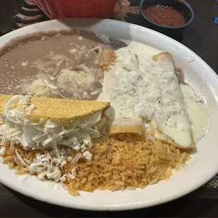 Chicken Taco, Cheese Enchiladas with onion, Rice and Beans.