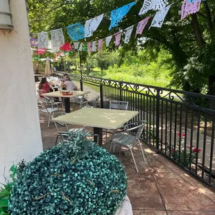 a patio with tables and chairs