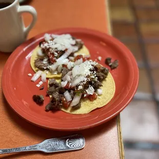 a plate of tacos and a cup of coffee