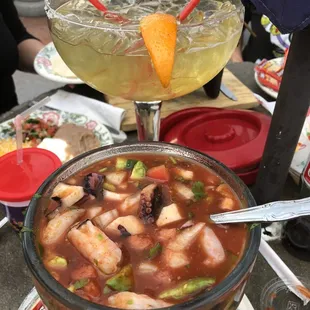 a bowl of soup and a drink