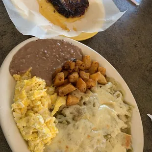 Chilaquiles verdes w/ scrambled eggs, papas, and beans. And chuletas a la carte.