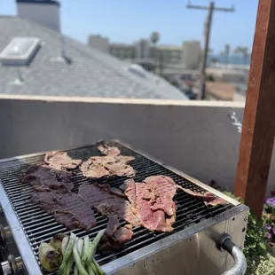 a grill with meat and vegetables on it