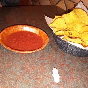 a bowl of chips and a bowl of salsa