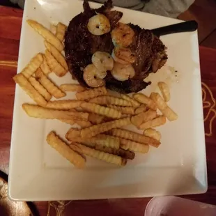 Steak with shrimp and fries.