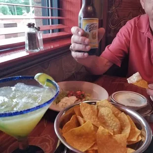 a man holding a bottle of beer