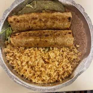 Two ground beef flautas with rice and beans