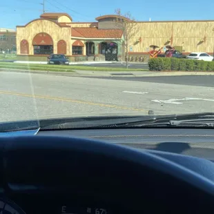 a view of a parking lot from inside a car