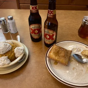a plate of food and a bottle of beer