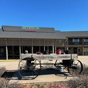 a horse drawn wagon outside a restaurant