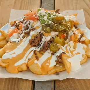 Our Asada Fries are topped with our homemade chile con queso!