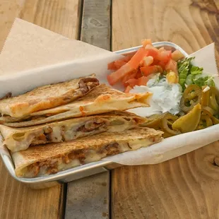 Our Quesadillas are made with a 12 inch, locally made, flour tortilla and Monterrey jack cheese.