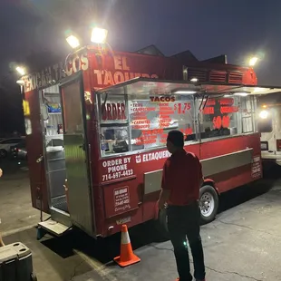 a man standing in front of a food truck