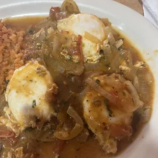 Close up of the 3 eggs in the ranchero sauce