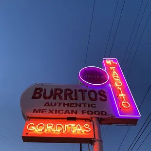 a neon sign for burritos